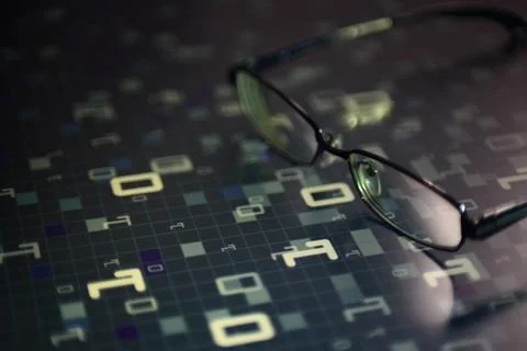 Big data analysis. glasses placed on a LED digital panel display white light Stockfoto's