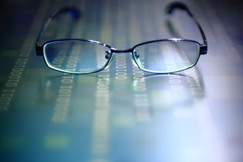 Big data analysis. glasses placed on a LED digital panel display white light Stockfoto's