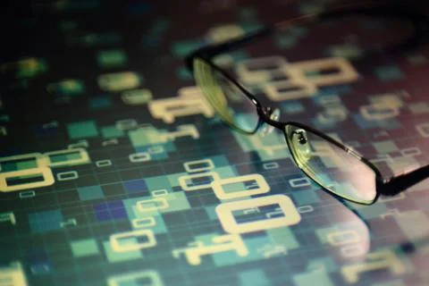 Big data analysis. glasses placed on a LED digital panel display white light Stockfoto's