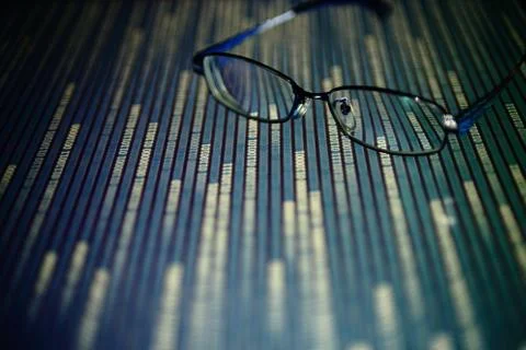 Big data analysis. glasses placed on a LED digital panel display white light Stockfoto's