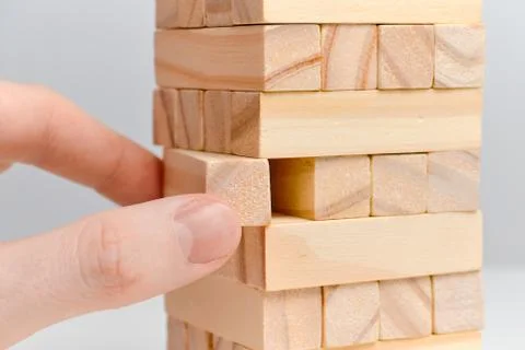 Big date moderation concept. Hand holds wooden blocks on a white background. Stock Photos