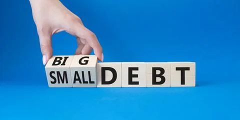 Big debt and small debt symbol. Businessman hand. Turned cubes with words B.. Stock Photos