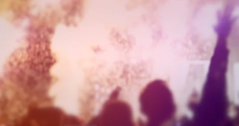 Big defocused crowd with hands in the air at  concert with confetti and lights Stock Footage 130482322