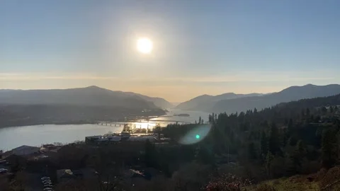 Big diffused sunball timelapse sunset down center of Columbia River Gorge Stock Footage 264775166