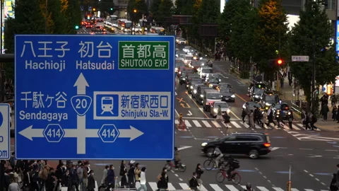 Big direction sign at busy intersection in Shinjuku in the evening. Tokyo, Japan Stock Footage 249661951