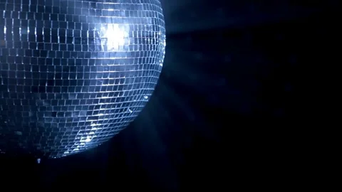 Big disco ball close up on dark background. disco ball illuminates the back.. Stock Footage 265756086