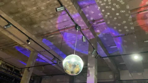 Big disco ball hanging from the ceiling in an industrial-style building. Stock Footage 200268071