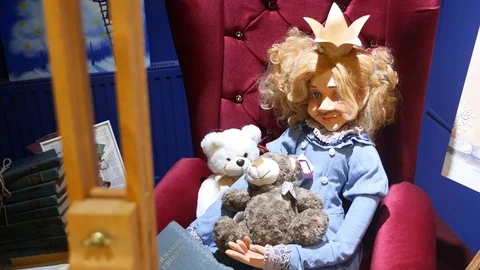 Big doll sits on a chair Stock Footage 101571815