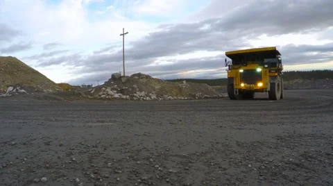 Big downloaded juggernaut with headlights leaves the quarry. Video stock 55357869