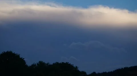 Big dramatic cloud timelapse over trees silhouettes Stock Footage 315435971