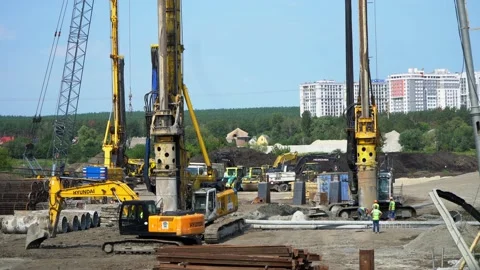 Big drilling machine making holes to lift pillars in the construction of a Stockbeeldmateriaal 221256983