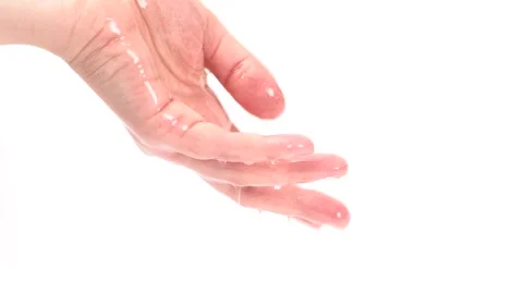 Big drops of moisturizing lotion with shimmer pouring into hand and flows f.. Stock Footage 275048820