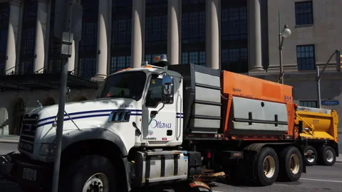 Big dump trucks blocking traffic to protect protestors from potential attack Stock Footage 132204346