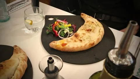 Big dumpling on black plate Stock Photos