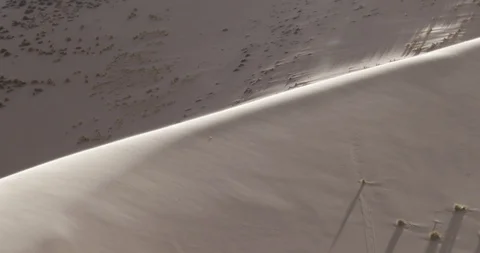 Big dune with wind blowing sand over surface at sunset, detail of dune's top 스톡 동영상 103498666