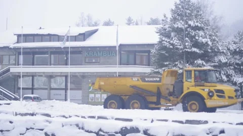 Big earth-moving machine on a road in snow, Norway Video stock 169571838