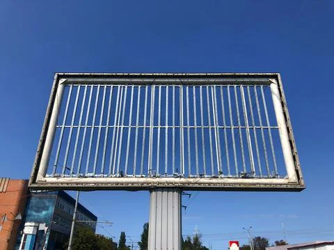 Big empty billboard without inscriptions and ads on the blue sky background Stock Photos