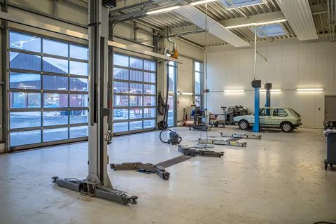 In big empty car workshop there are some car lifts Stock Photos
