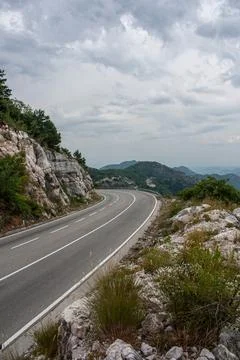 Big empty road with left turn in a mountains Stock Photos