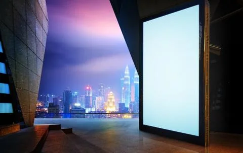 Big empty screen billboard with modern city background . Stock Photos