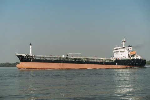 Big, empty shipping boat going up Chao Praya River in Pak Nam, Thailand. Stock Photos