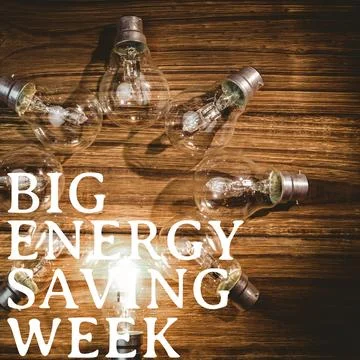 Big energy saving week text banner against multiple light bulbs on wooden Stock Photos