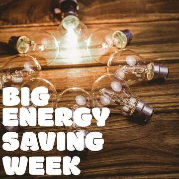 Big energy saving week text banner against multiple light bulbs on wooden Stock Photos