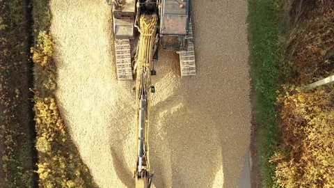 Big excavator during loading sand at construction site aerial footage. Stock Footage 97798297