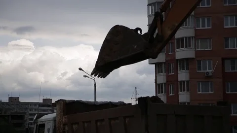 Big excavator loading truck with ground at the construction site. Stock Footage 78183945
