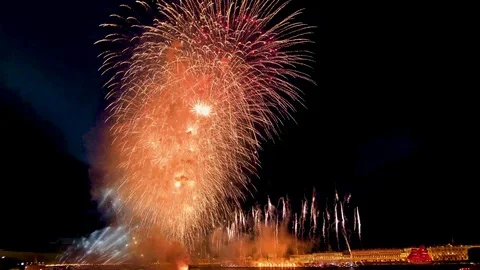 Big explosions of fireworks lighting up the night city on the water Stock Footage 111516630
