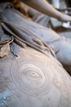 Big eye on the stone shield of an ancient statue Stock Photos
