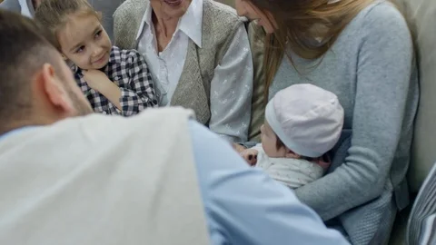 Big Family Cooing over Cute Baby Stock Footage