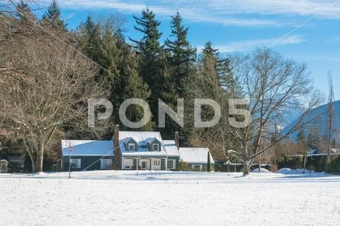 Big farmers house with spacious front yard on sunny winter day in Canada Stock Photos