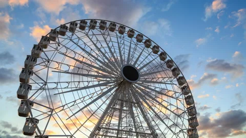 Big Ferris wheel time lapse against colorful sunset sky at dusk Stock Footage 150827410