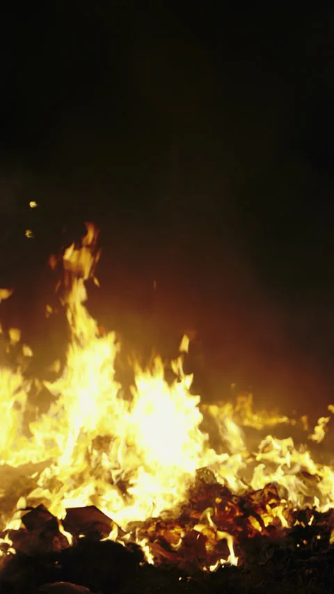 Big fire destroys unauthorized waste landfill on dark background at night Stock Footage 315439391