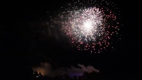 Big fireworks during a celebration in the middle of the countryside. Night sky Stock Footage 321354425