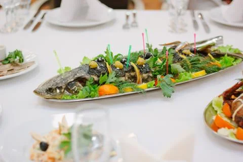 Big fish on table during catering event. Catering buffet. Stock Photos