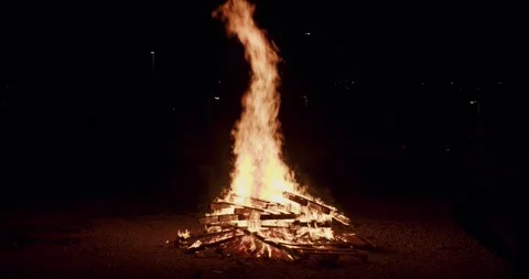Big flame bonfire burn in the middle of night of spring celebration  slowmotion Stock Footage 277351786