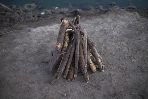 Big flame flutters in wind. Bonfire made of branches of fruit trees. Stock Photos