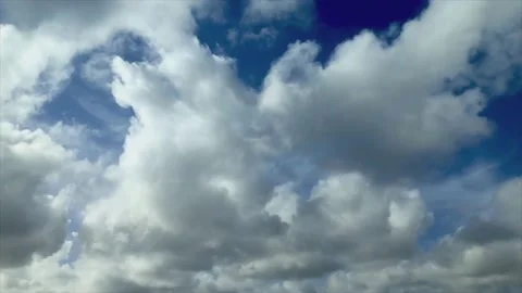 Big fluffy clouds passing by the blue sky timelapse Stock Footage 152173231