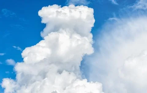 A Big fluffy white cloud in the blue sky. Stock Photos