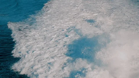Big foam waves trail after a traveling cruise ship Stock Footage 122793487