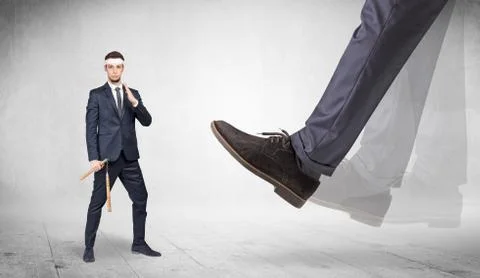 Big foot trample suited karate man Stock Photos