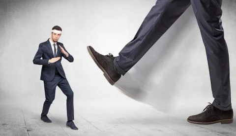 Big foot trample suited karate man Stock Photos