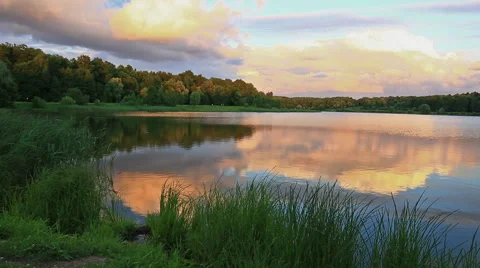 Big forest lake at sunset, in the sky beautiful clouds Video stock 63662609