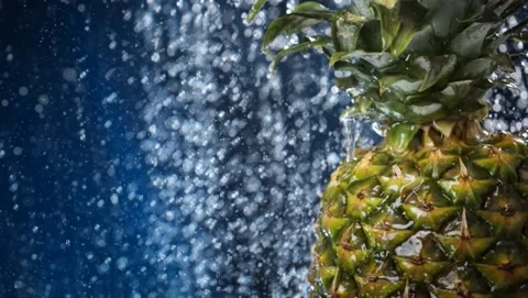 Big fresh pineapple close up under the water drops. Water splash . Stock Footage 132747159