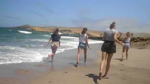 Big group friends beach run vacations in Paracas National Park, Pisco, Peru. Stock Footage 125277367