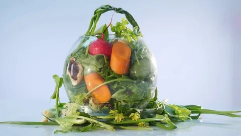 Big group of vegetables on a vase on white background Stock Footage 78752977