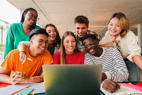 Big group of young students using a laptop to do the homeworks at high school Stock Photos