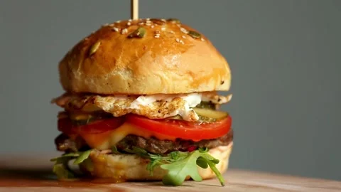 BIG Hamburger or cheeseburger with cutlets, Delicious hamburger background. food Stock Footage 336579361